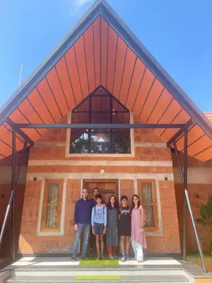 a group of people standing in front of a building at Senthamarai villa in Sultan Bathery