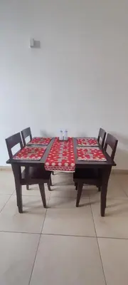 a table with two chairs sitting next to at OOTY LIMRA HOLIDAY INN cottage in Ooty