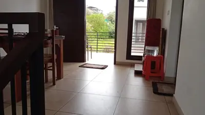 a kitchen and dining room with a door to a balcony at OOTY LIMRA HOLIDAY INN cottage in Ooty