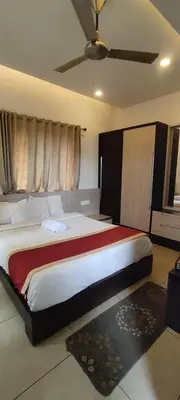 a bedroom with a large bed in a room at OOTY LIMRA HOLIDAY INN cottage in Ooty