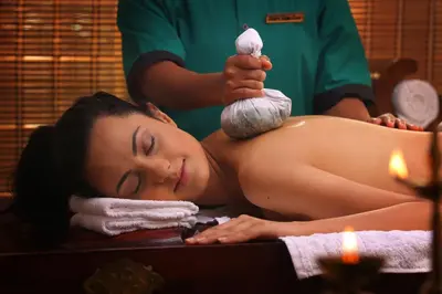 a woman getting a massage in a bath tub at Peter's Coffee Creek Wayanad Pool Resort in Wayanad