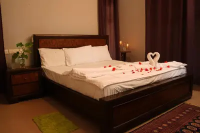 a bedroom with a bed with red roses on it at Bellevue Homestay and Wellness Centre in Kozhikode