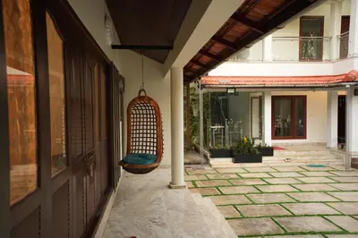 a swing hanging from the side of a building at Bellevue Homestay and Wellness Centre in Kozhikode