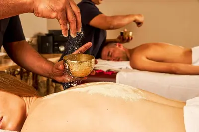 a man holding a cup in front of a woman at Bellevue Homestay and Wellness Centre in Kozhikode