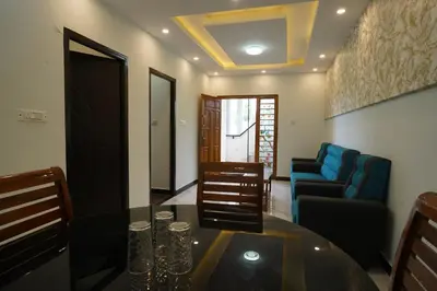a living room with a table and a couch at Casa de Selas in Coonoor