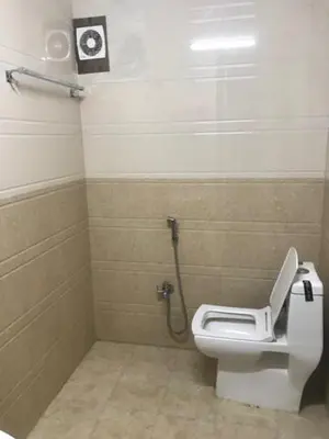 a bathroom with a white toilet in a stall at Misty Stay by Le Apex in Ooty