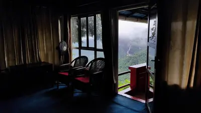 a room with chairs and a window with a view at Valley View Avenue in Meppādi