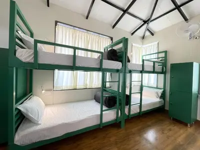 a bunk bed room with two bunk beds at ABODE Backpacker's Hostel in Madikeri