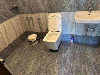 a bathroom with a toilet and a sink at Farm stay in a coffee plantation near Athirappally in Kodali