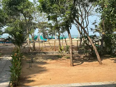 a view of a beach with trees and a fence at Ocean Whisper- psst! hidden gem in Kaipamangalam