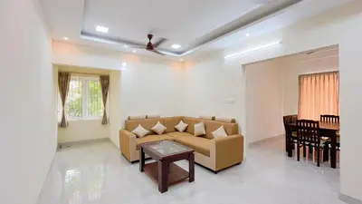 a living room with a couch and a table at Thapovan coimbatore in Coimbatore