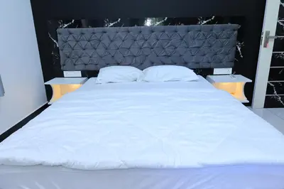a large white bed with two pillows on it at Iyer Square in Attappādi