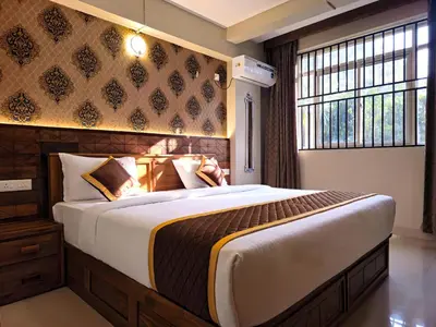 a bedroom with a large bed and a window at Alicos Residency in Sultan Bathery