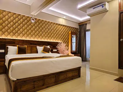 a bedroom with a large bed in a room at Alicos Residency in Sultan Bathery