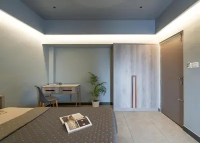a bedroom with a bed and a table and a desk at YMCA International Guest House in Trichūr