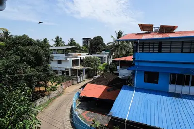 arial view of a city with a blue building at Ganga Homes Rooms Only in Trichūr
