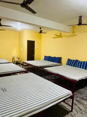 a row of mattresses lined up in a room at Woodland residency in Mettuppālaiyam