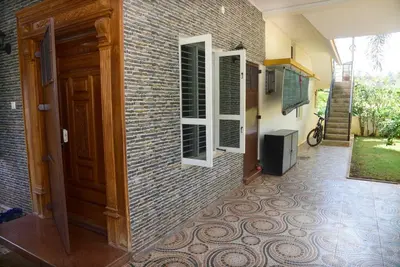 a brick building with a door and a tile floor at S R Luxurious Fully Ac 3 BHK Bunglow Mysore in Mysore