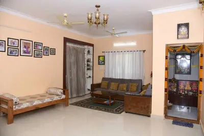 a living room with a couch and a table at S R Luxurious Fully Ac 3 BHK Bunglow Mysore in Mysore