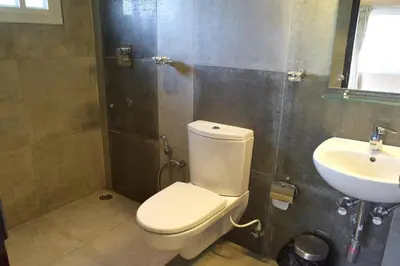 a bathroom with a toilet and a sink at Avadale Kodaikanal - Stag Groups Not Allowed in Kodaikānāl
