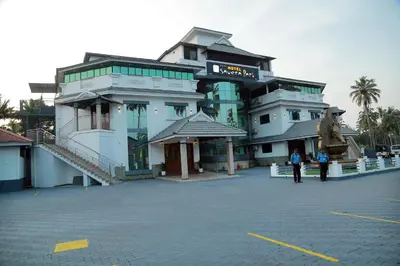a large building with people standing in front of it at Hotel Savera Park in Trichūr