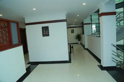 a hallway of a building with a light on the wall at Hotel Savera Park in Trichūr