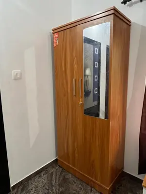 a wooden door in a room with a mirror at Montage Villa in Kozhikode