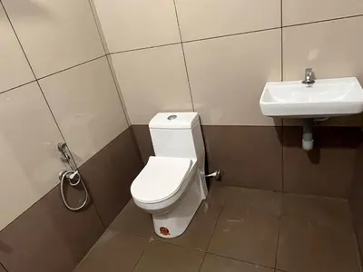 a bathroom with a toilet and a sink at Montage Villa in Kozhikode