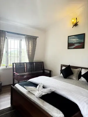 a bedroom with two beds and a window at Earth songs by Green leaves - 10 kms from kotagiri in Kotagiri