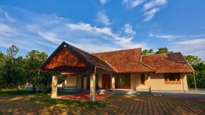 a house with a shingled roof at Silvertrails in Kalpetta