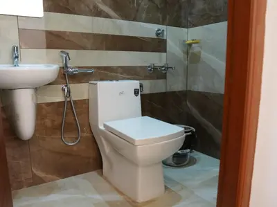 a bathroom with a toilet and a sink at Neom's Golden Gate in Alwaye