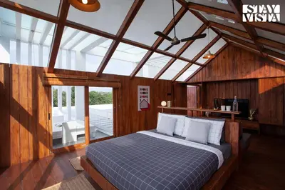a bedroom with a bed in a room with wooden walls at StayVista at Reflection by The Woods - Breakfast Included - Luxury Villa in Madikeri
