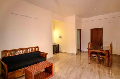 a living room with a couch and a table at Spectrum stays in Ambalavayal