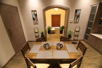 a dining room with a table and chairs at Cataleya in Kotagiri