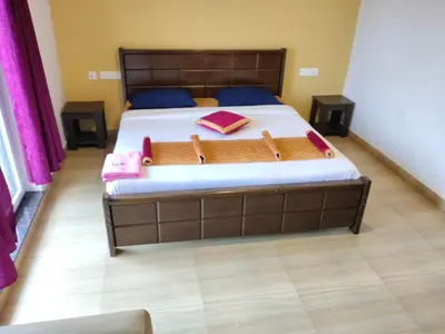 a bedroom with a large bed in a room at Forest Gate villa in Ooty
