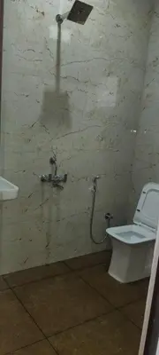 a bathroom with a toilet and a sink at Dream Nest Resort in Mettuppālaiyam