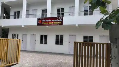 a building with a sign that reads urgent risk benefits at Dream Nest Resort in Mettuppālaiyam