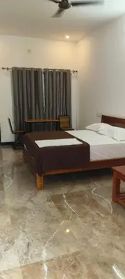 a bedroom with two beds and a ceiling at Dream Nest Resort in Mettuppālaiyam