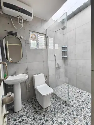 a bathroom with a toilet and a sink and a shower at Aadvik Luxury Farmstay in Antarasante