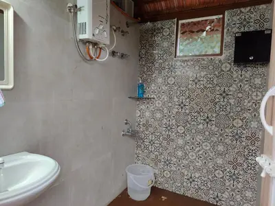 a bathroom with a toilet and a sink at Aadvik Luxury Farmstay in Antarasante