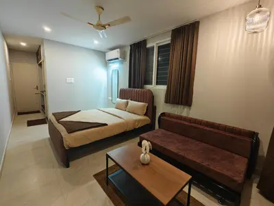 a living room with a bed and a couch at Aadvik Luxury Farmstay in Antarasante