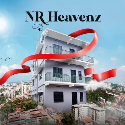 a white building with a red ribbon around it at NR HEAVENZ Near Rajagiri Hospital in Alwaye