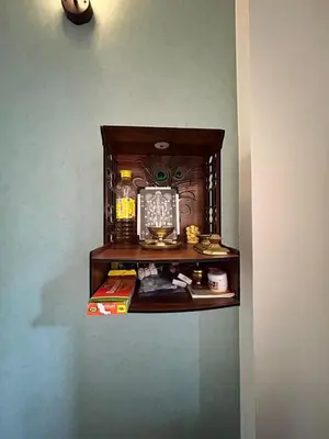 a shelf in the corner of a room at 1 BHK Fully Furnished - Soorya Madhavam Apartments - Flat No - C2 - Guruvayur, - 150m to North Nada - Family only in Guruvāyūr