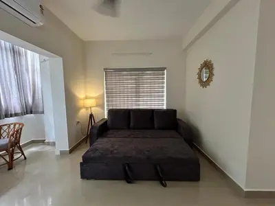 a bedroom with a bed in a room with a window at 1 BHK Fully Furnished - Soorya Madhavam Apartments - Flat No - C2 - Guruvayur, - 150m to North Nada - Family only in Guruvāyūr