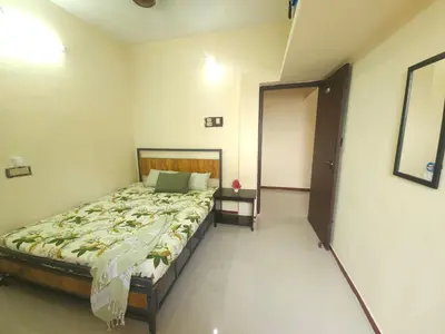 a bedroom with a bed and a door to a room at SHI's Ganga 2BHK in GN Mills, Ganga Hospital, Women's Care Coimbatore in Coimbatore