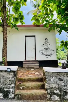 a building with a door with a drawing on it at Haven Stay Manor in Kotamangalam