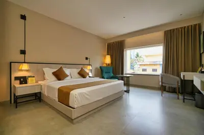 a bedroom with a bed and a desk and a window at mesta Hotel in Sultan Bathery