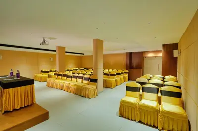 a conference room with yellow chairs and a table at mesta Hotel in Sultan Bathery