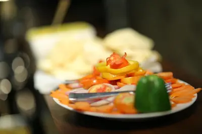 a plate of food with vegetables on a table at Sreepathi Indraprastha in Guruvāyūr