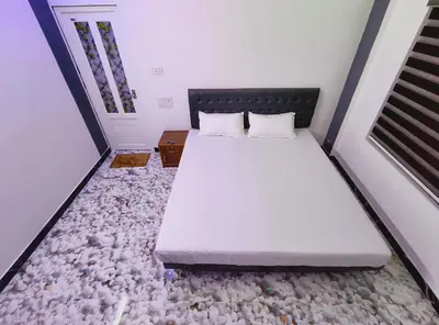 a bed in a room with rocks on the floor at Dream Nest Villa Wayanad in Kalpetta